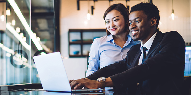 Two coworkers on laptop